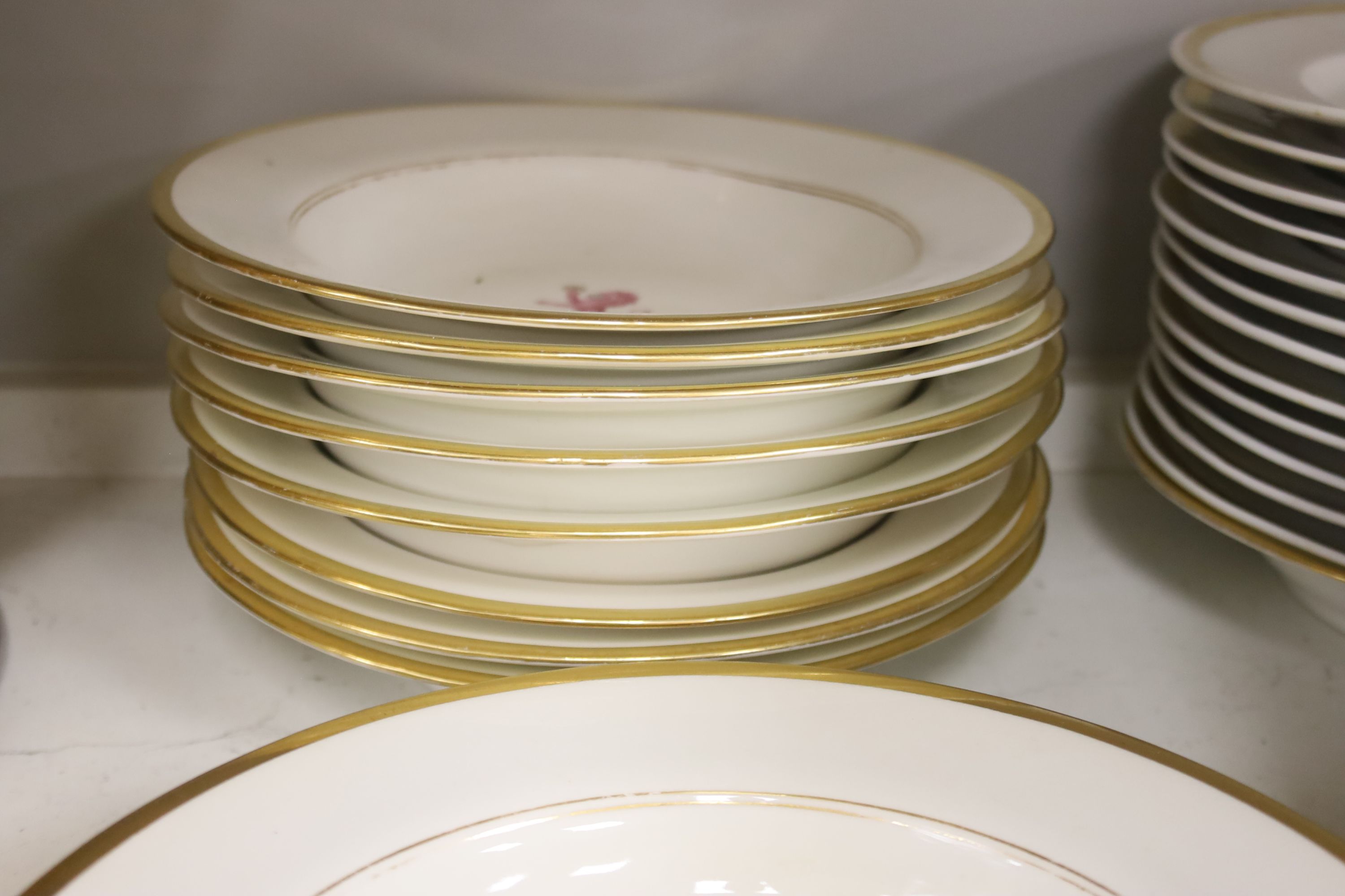 An early 19th century crested part dinner service, by Chamberlains Worcester, and another similar service